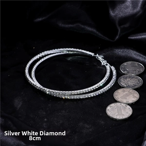 Macro detail of oversized silver hoop earrings with clear rhinestones and 8cm scale