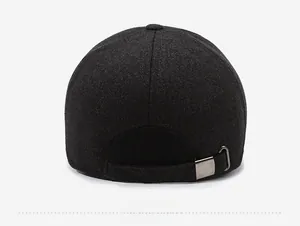 Detail of the back of a dark grey wool cap featuring a vintage metal buckle and strap