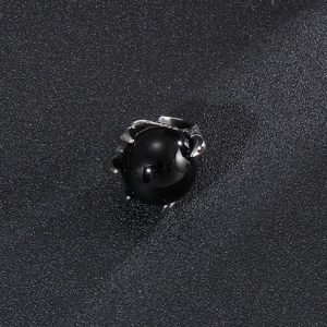 Punk style stainless steel dragon claw necklace with polished black stone on leather background