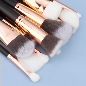 Macro shot of high-quality makeup brush bristles with rose gold ferrules on blue background