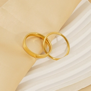 Polished gold double band titanium ring set on silk background for women