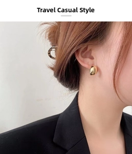 Close-up of elegant 18K gold-plated curved earrings worn by a model in French vintage style
