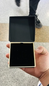Square black jewelry box with cream interior and black velvet lining for rings and studs