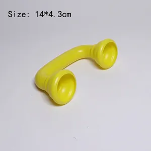 Detail view of a yellow vintage toy telephone handset, size 14x4.3cm made of plastic