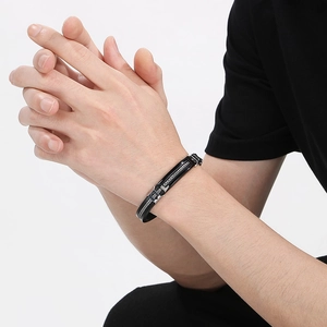 Men's adjustable silicone and stainless steel bracelet in black and silver on wrist