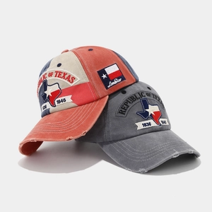 Detail of vintage washed cotton baseball caps with Texas embroidery and distressed brim