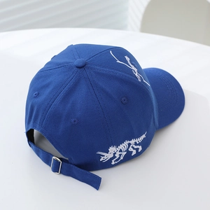 Navy blue kids baseball cap featuring white dinosaur skeleton embroidery and metal buckle