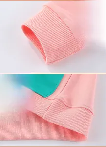 Detail of elastic ribbed cuffs and stitched hem on a color-block kids sweatshirt