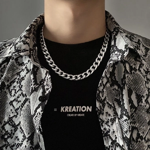 Grosse chaîne gourmette argentée style Cuban link portée par un mannequin streetwear