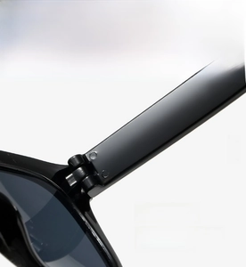 Detailed macro view of the sturdy metal hinge and screw design on square sunglasses