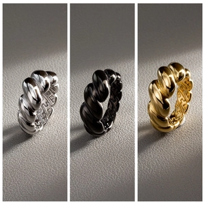 Three-color croissant dome rings in gold, silver and black with polished twisted texture