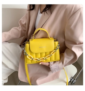 Fashionable yellow quilted shoulder bag featuring a stylish thick chain and long strap