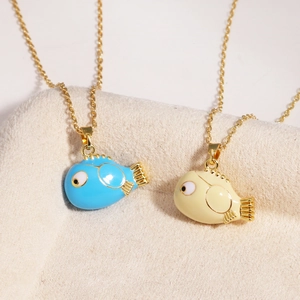 Macro view of cartoon fish pendants in blue and beige on stainless steel chains