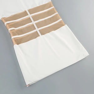 Detail of white mesh patchwork dress featuring criss-cross ribbons and side zipper
