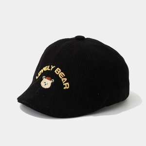 Detailed texture of black corduroy beret with yellow Lovely Bear embroidery for toddlers