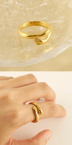 Detail of 18k gold plated stainless steel hug ring showing model wearing the embrace design