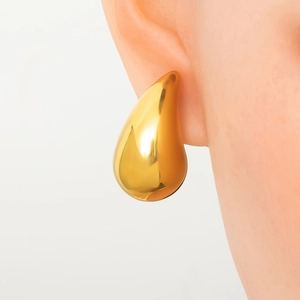 Polished gold drop earrings showing high-shine metallic finish and elegant scale on ear