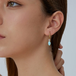 Elegant gold-plated hoop earrings with sparkling zircon and light blue enamel droplets
