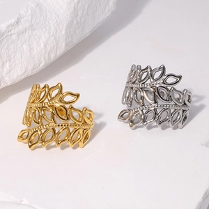 Minimalist 18K gold and silver hollow leaf open rings on elegant stone props