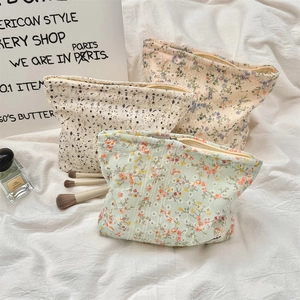 Close-up of floral embroidery on cotton canvas makeup bags with zip closure