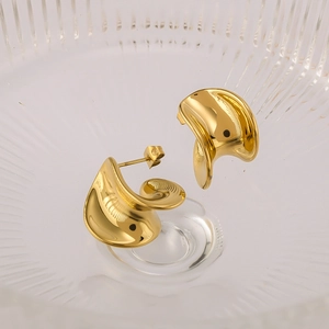 Polished 18K gold plated geometric twisted earrings displayed on a glass tray