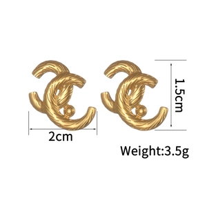 Detail view of gold earrings with woven texture and 2cm by 1.5cm dimension specs