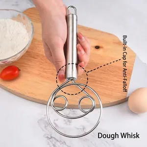Stainless steel Danish dough whisk with ergonomic handle on a wooden board with ingredients