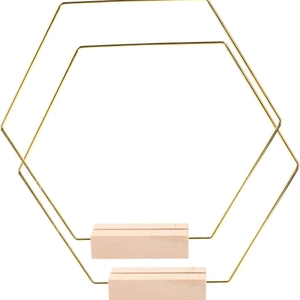 Golden hexagonal metal floral hoop with natural wooden base for wedding table centerpieces