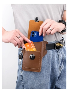 Close-up of brown leather belt phone holster with magnetic closure and key attachment
