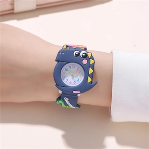 Detailed view of dark blue dinosaur cartoon watch with silicone strap on a child wrist