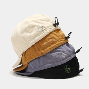 Stacked vintage soft brim baseball caps in beige yellow and black with adjustable cords