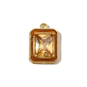 Detail of a vintage golden rectangle pendant with a step-cut amber stone inlay
