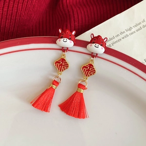 Detail of Chinese style tassel earrings with festive red dragon and gold Fu character