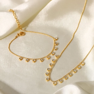 Elegant gold stainless steel necklace and bracelet set with sparkling rhinestone charms