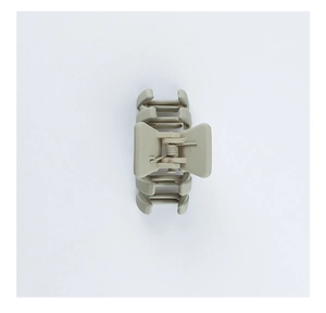 Detail view of khaki matte hair claw clip showing textured shark clip design