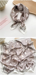 Detailed view of Morandi gray silk scarf with playful cartoon cat prints and soft texture
