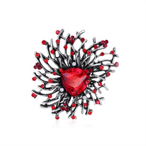 Macro shot of silver-tone coral branch brooch featuring red triangular rhinestone inlay