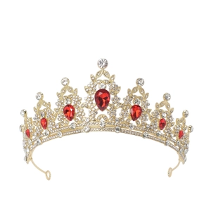 Detailed close-up of a royal gold crown featuring red rubies and clear rhinestones