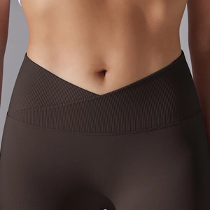 Detail of high-waisted V-shaped crossover waistband on ribbed knit yoga leggings