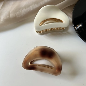 Set of two medium acetate shark clips in solid white and tortoise shell pattern for women