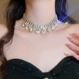 Close-up of sparkling rhinestone choker with teardrop pendant on a model's neck