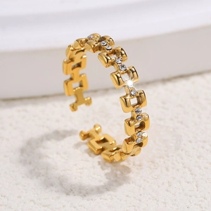 Macro shot of gold adjustable chain ring with sparkling zircon stones and hollow link design