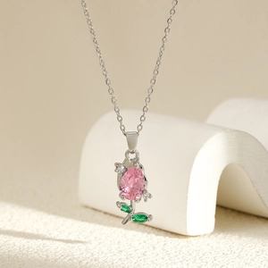 Detail of pink pear-shaped tulip pendant necklace with green marquise stone leaves