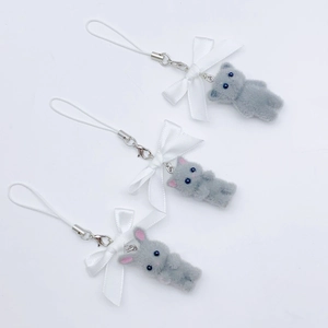 Y2K grey flocked cat phone charms with white ribbon bows and beaded straps on white background