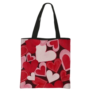 Polyester tote bag with red and pink heart patterns and black handles for Valentine's gift