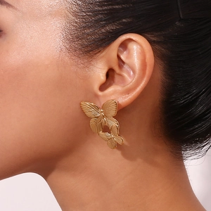 18K gold plated stainless steel double butterfly stud earrings on female model