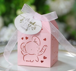 Close-up of pink elephant hollow candy box with ribbon and Thank You tag on a plate