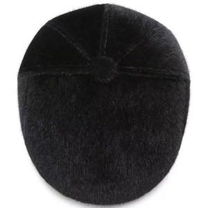Top view of a thick black faux fur beret cap showing warm plush texture and stitch detail