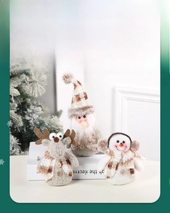 Close-up of plush Christmas reindeer, Santa, and snowman dolls with plaid fabric details