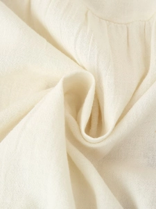 Macro shot of off-white cotton-linen fabric texture with natural weave and soft folds
